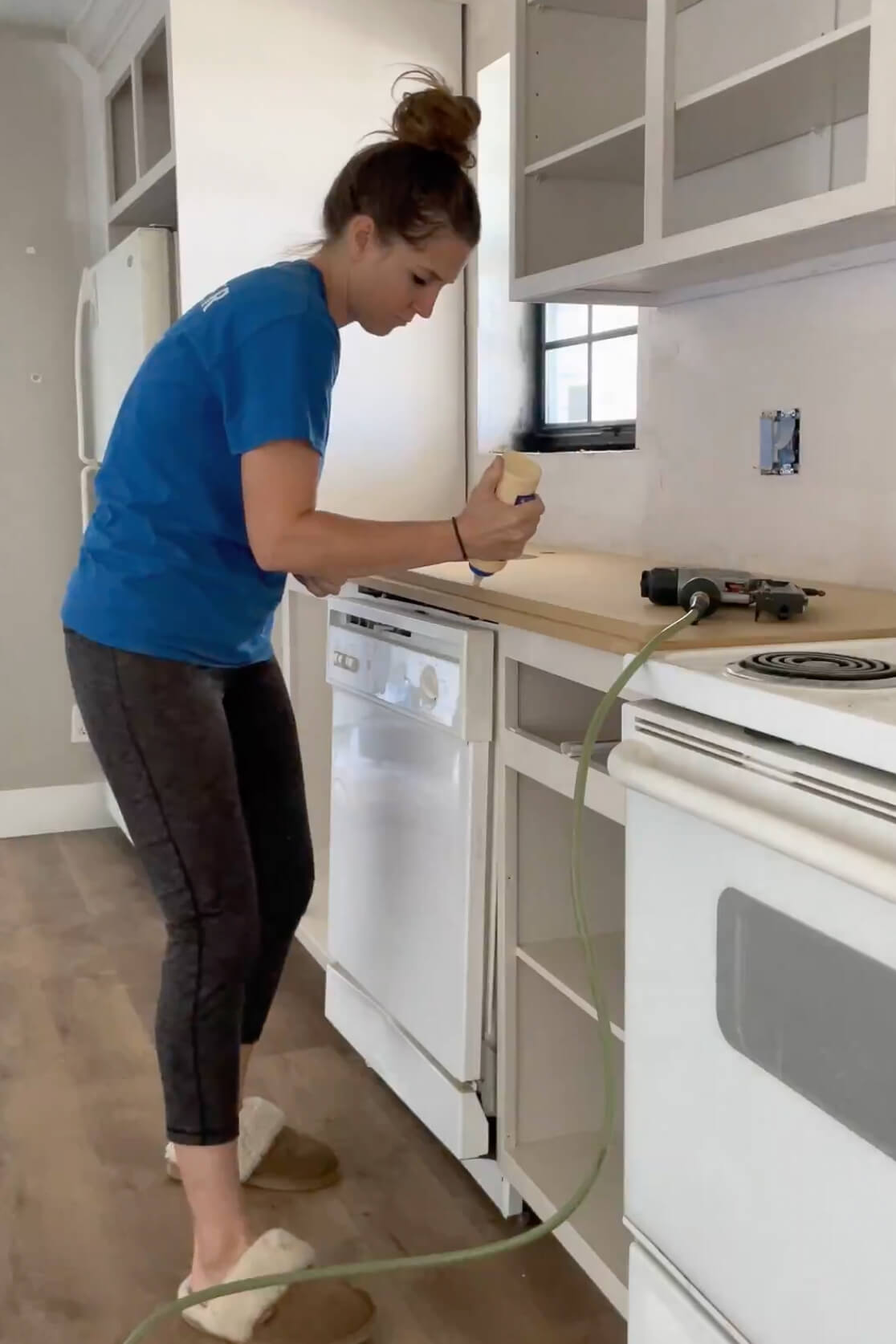 Using wood glue to attach the edge of the DIY countertop.